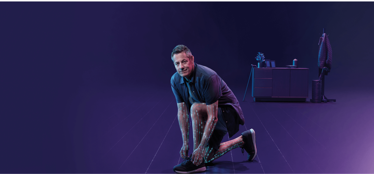 Header image: man kneeling tying his shoe with nerves activating along his arms and legs